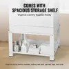 A white washing machine stand with a storage shelf below, holding laundry supplies and towels. Voir les images du produit