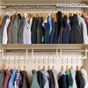 Two shelves of a closet filled with clothes organized on hangers. The top shelf shows clothes hanging directly on a rod, while the bottom shelf features a space-saving hanger organizer system. Podgląd zdjęcia produktu