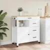 A white kitchen cart with a wooden top is shown in a room with a large plant and other kitchen items in the background. Náhled obrázku produktu
