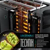 A cutaway view of a toaster showing its internal heating elements and construction, with a slice of avocado toast in the foreground. Produktbild-Vorschau