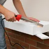 A person is using a hot wire cutter to cut a piece of white styrofoam insulation. Podgląd zdjęcia produktu