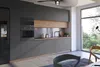 A modern kitchen with dark gray cabinets, a built-in oven, and a large window overlooking a lush green landscape. Produktbild-Vorschau