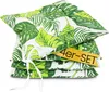 A stack of four green and white leaf-patterned seat cushions tied together with a white ribbon.