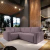 A modern living room with a large sectional sofa, large windows overlooking a forest, and wooden architectural elements.