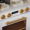 A close-up view of a toy kitchen's control panel and oven door. Náhľad obrázku produktu