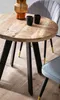 A round wooden dining table with black legs and gold accents, set with two black cups and a decorative vase. A chair is partially visible in the background. Anteprima dell’immagine prodotto