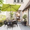 A patio dining set with a lime green umbrella on a balcony. Produktbild-Vorschau