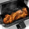 Fried chicken drumsticks being cooked in an air fryer. Podgląd zdjęcia produktu