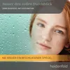 A close-up of a young woman's face with red hair, partially obscured by a steamy, water-droplet-covered surface, suggesting a bathroom mirror. Produktbild-Vorschau