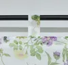 A close-up view of a floral patterned curtain hanging from a rod. Produktbild-Vorschau