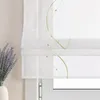 A close-up of a white Roman blind with green embroidered wavy lines and beads, next to a vase of lavender. Produktbild-Vorschau