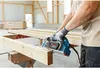 A person is using a power planer on a wooden beam in a workshop. Anteprima dell’immagine prodotto