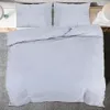 A top-down view of a gray duvet cover and two pillowcases on a bed. Náhled obrázku produktu