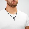 A man wearing a white t-shirt and a black cross necklace. Podgląd zdjęcia produktu