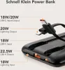 Close-up view of a black power bank with various ports and cables, with text annotations highlighting its features. Produktbild-Vorschau