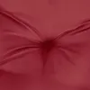 A close-up shot of a red cushion or fabric with tufting. Voir les images du produit