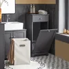 A bathroom scene featuring a gray cabinet with an open compartment and a laundry basket. Anteprima dell’immagine prodotto