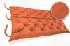 A tufted orange bench cushion on a white background. Produktbild-Vorschau