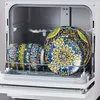 A dishwasher rack filled with colorful, patterned plates and bowls. Náhled obrázku produktu