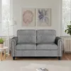 A gray sofa is shown in a well-lit room with two floral paintings on the wall. Produktbild-Vorschau