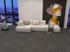 A modern living room with a sectional sofa, a large abstract painting, and a city view through a large window. Produktbild-Vorschau
