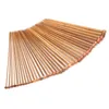 A collection of wooden knitting needles fanned out on a white background. Podgląd zdjęcia produktu