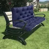 A dark blue tufted cushion set on a black metal garden bench with white slatted backrests, placed on a green lawn. Produktbild-Vorschau