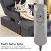 A woman sitting on an electric recliner sofa, with a close-up of the recliner switch. Produktbild-Vorschau