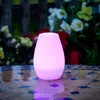 A pink LED light sits on a mosaic table with flowers in the background. Produktbild-Vorschau