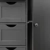 A close-up view of a dark gray wooden dresser with multiple drawers and a partially open door revealing a silver knob. Podgląd zdjęcia produktu
