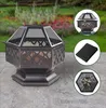 A fire pit with accessories displayed on a patio with a garden in the background. Anteprima dell’immagine prodotto