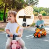 Two young children are riding balance bikes outdoors on a paved path. Anteprima dell’immagine prodotto