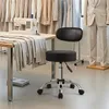 A sewing room with a sewing machine on a table, fabric, and a mannequin in a suit. Produktbild-Vorschau