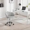 A light gray velvet office chair with a scalloped back is placed in front of a white desk in a well-lit room. Produktbild-Vorschau