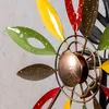Close-up of a colorful metal wind spinner with petal-shaped blades. Produktbild-Vorschau