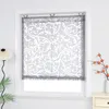 A window with a patterned roller blind is shown. Produktbild-Vorschau