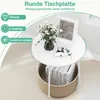 A round side table with a storage basket underneath, decorated with flowers and a picture frame. Anteprima dell’immagine prodotto