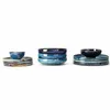 Three stacks of ceramic bowls and plates in various shades of blue and brown, arranged on a white background. Produktbild-Vorschau