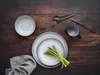 A top-down view of a table setting with plates, cutlery, a mug, and asparagus. Náhľad obrázku produktu