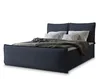 A navy blue upholstered bed with white pillows and a gray blanket, presented against a white background. Produktbild-Vorschau
