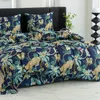 A bed with a duvet cover and pillows featuring a jungle print with leopards. Náhľad obrázku produktu