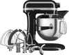 A black KitchenAid Artisan stand mixer with its attachments. Produktbild-Vorschau