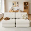 A modern living room or office space with a beige sofa, a wooden desk, and a bookshelf. Produktbild-Vorschau