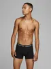 A man wearing black boxer shorts against a plain background. Produktbild-Vorschau