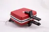 A red waffle iron with black accents and feet, shown on a white background. Anteprima dell’immagine prodotto