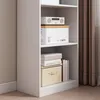 A white bookshelf with various items on its shelves, including boxes and books. A brown curtain is visible in the background. Podgląd zdjęcia produktu