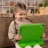 A young girl is sitting on a couch and using a tablet with a green protective case. Produktbild-Vorschau