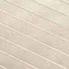 A close-up, angled view of a pleated fabric with a textured surface and thin white lines running diagonally across it. Produktbild-Vorschau