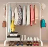 A white metal garment rack with clothes and accessories displayed. Náhled obrázku produktu