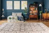 A bedroom scene with a bed, rug, bookshelf, and other decor. Produktbild-Vorschau